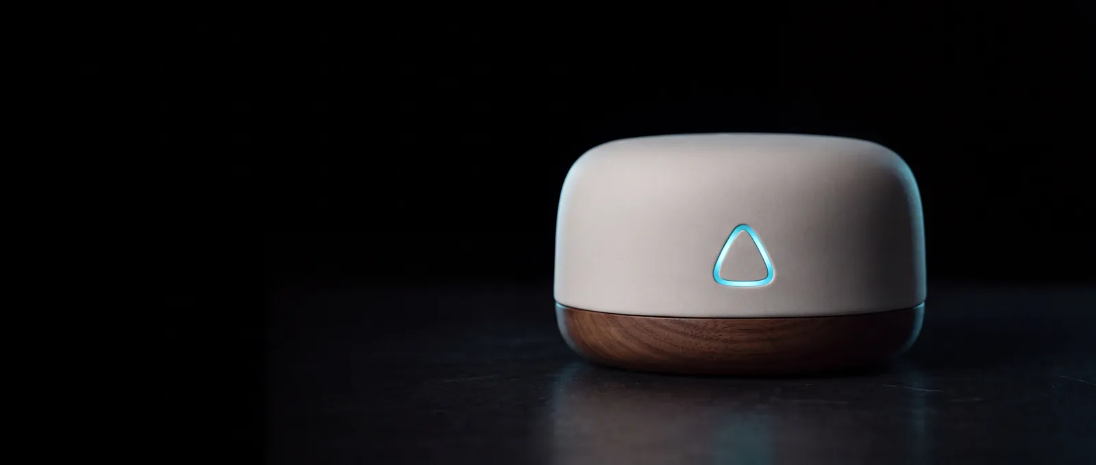 The ALYT hub in matte white and walnut with its cyan triangle illuminated